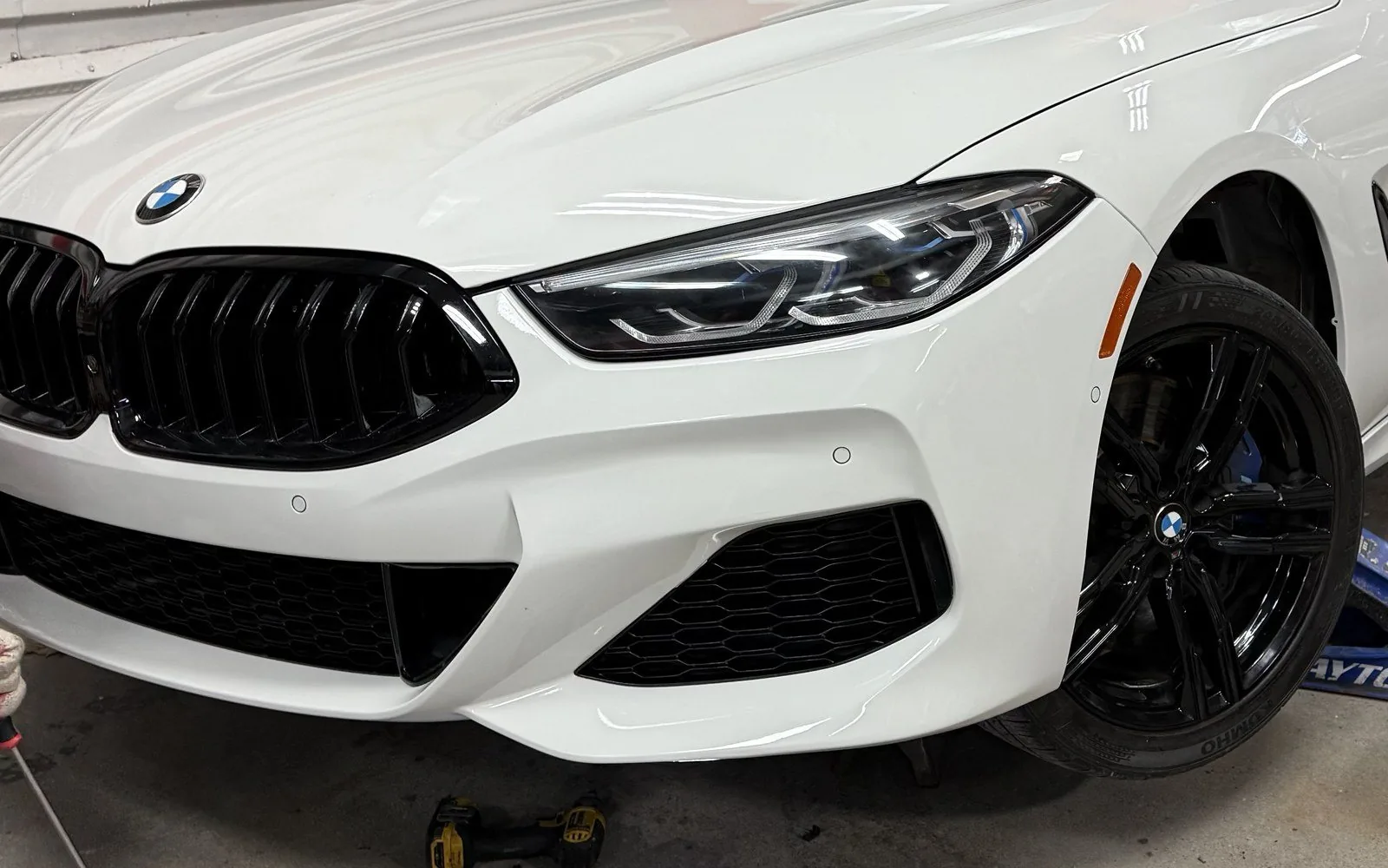The same white BMW 8 Series with the front end rebuilt and color matched after collision repair at Exclusive Collision & Repair in Brooklyn, NY