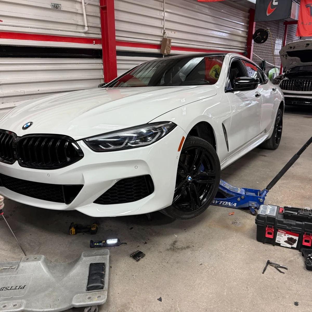 Same white BMW 8 Series repaired and refinished after auto body repair at Exclusive Collision & Repair in Brooklyn, NY