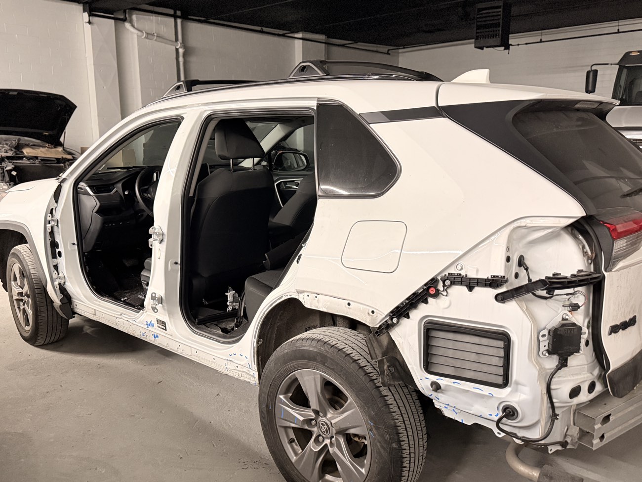 Toyota RAV4 with doors and rear panels removed for unibody measurement during automotive frame repair at Exclusive Collision & Repair in Brooklyn, NY